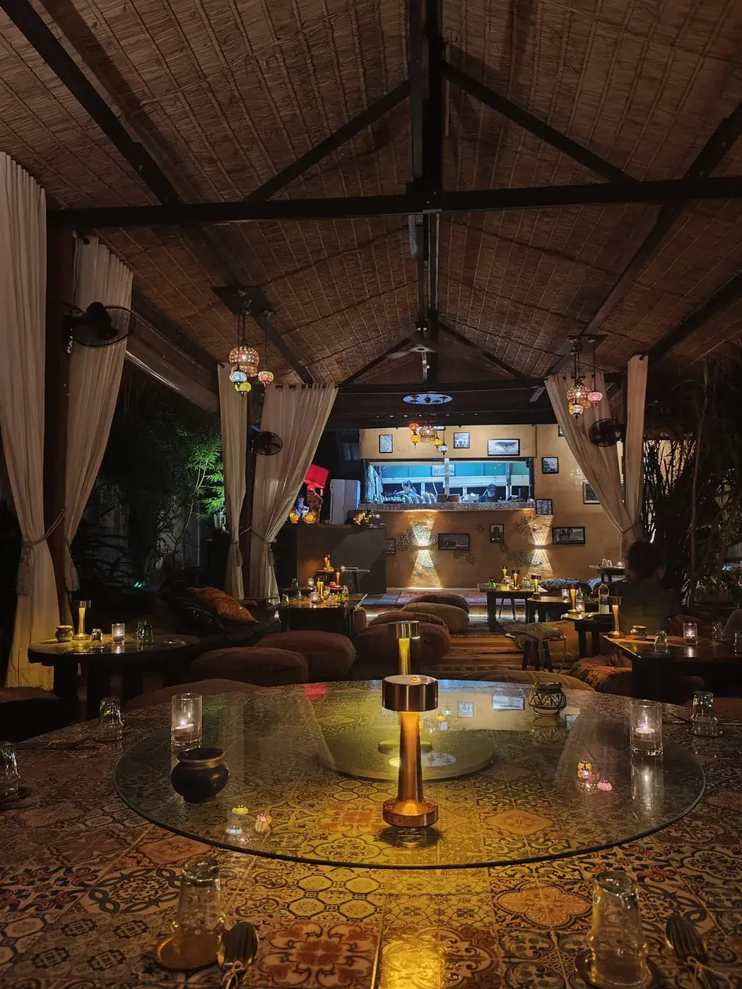 Warm ambient lighting in the main dining room at Dar Mansour Koh Phangan, creating an intimate Moroccan atmosphere